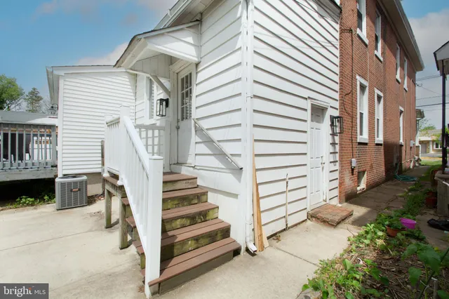 a view of a house with a yard and stairs