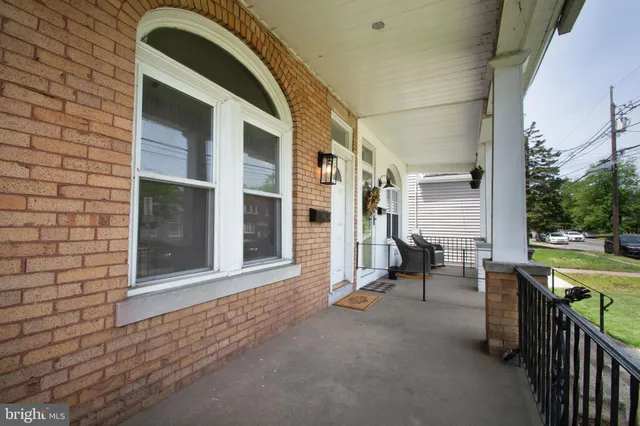 a view of a porch with a table and chairs
