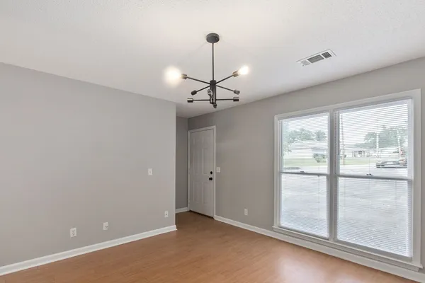 a view of a room with window wooden floor