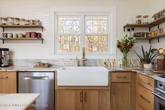 a kitchen with a sink a window and cabinets