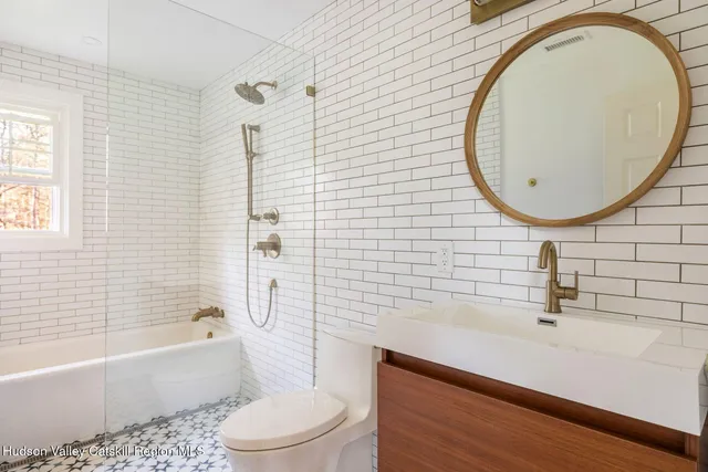 a bathroom with a sink a toilet and bathtub