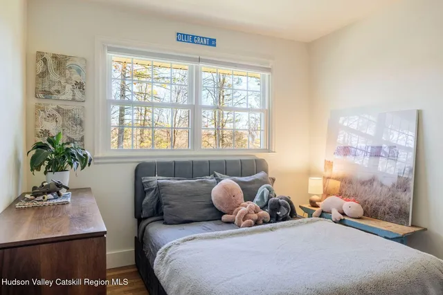 a bedroom with a bed and a potted plant