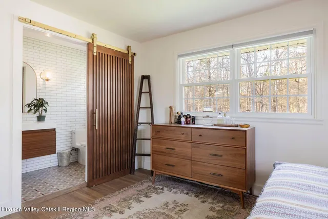 a room with a dresser and a window