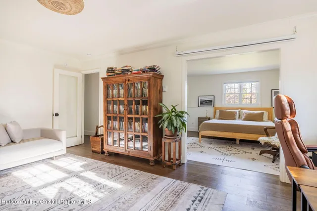 a living room with furniture a rug and a window