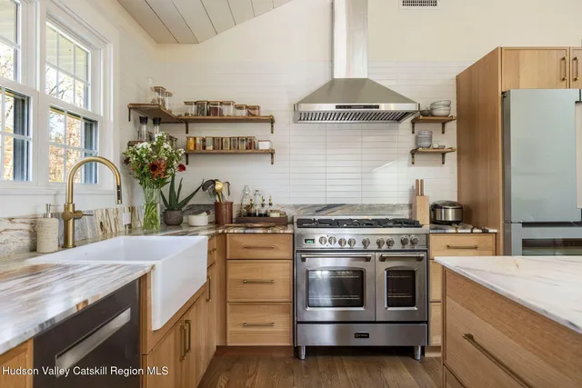 a kitchen with granite countertop a stove and a sink