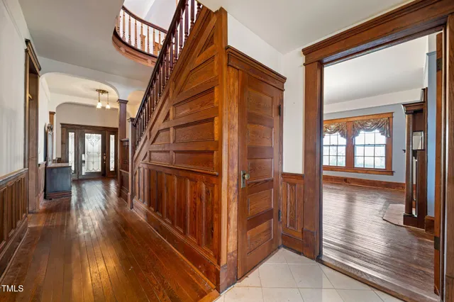 a view of a livingroom with a fireplace wooden floor and window