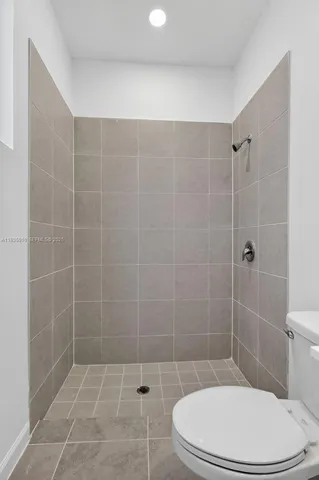 a bathroom with a toilet and shower