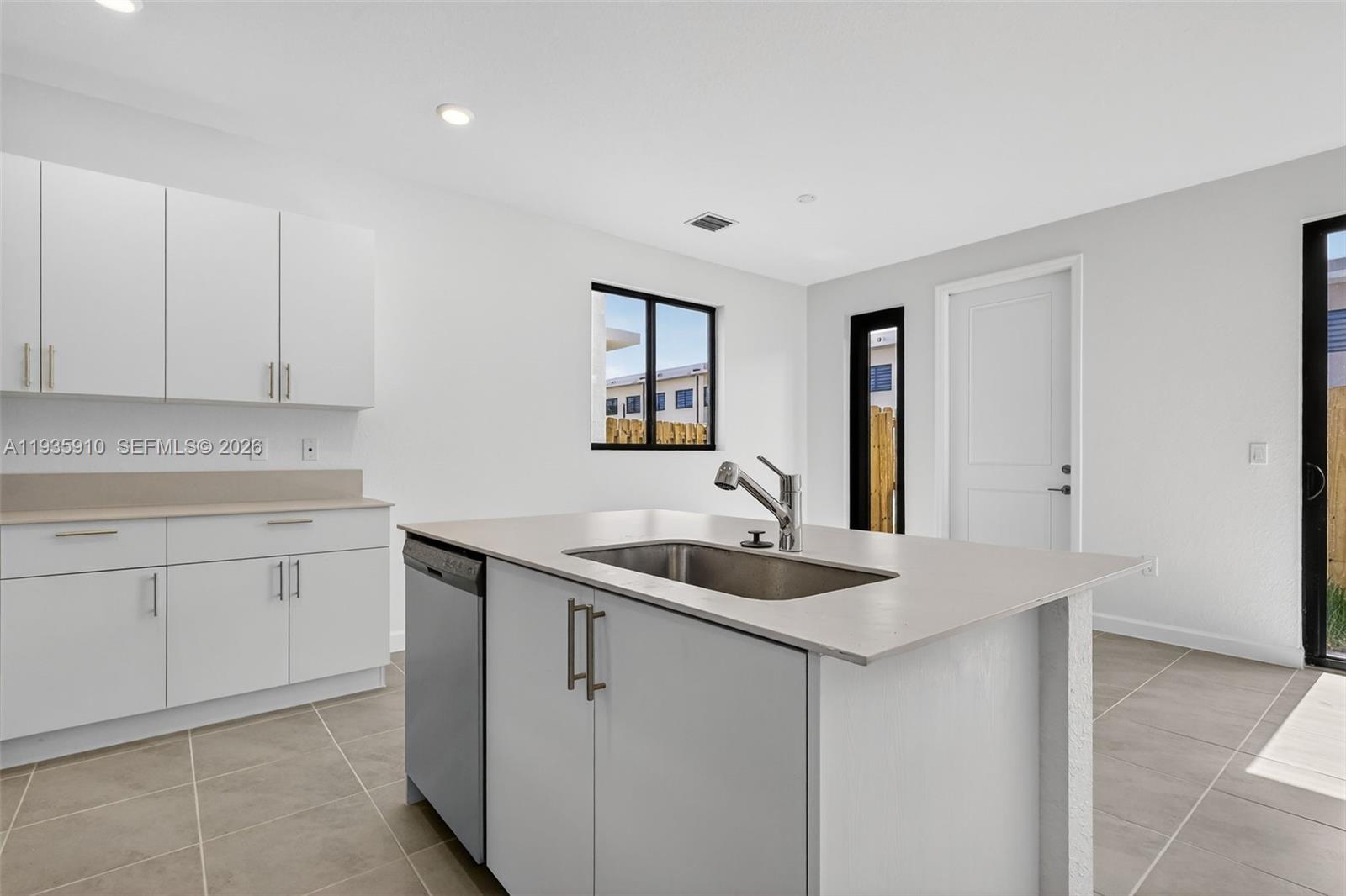 13872 Southwest 262nd Street, Unit 13862 Homestead, FL 33032 - Photo 11 of 43 a kitchen with a sink and cabinets