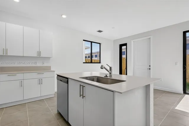 a kitchen with a sink and cabinets