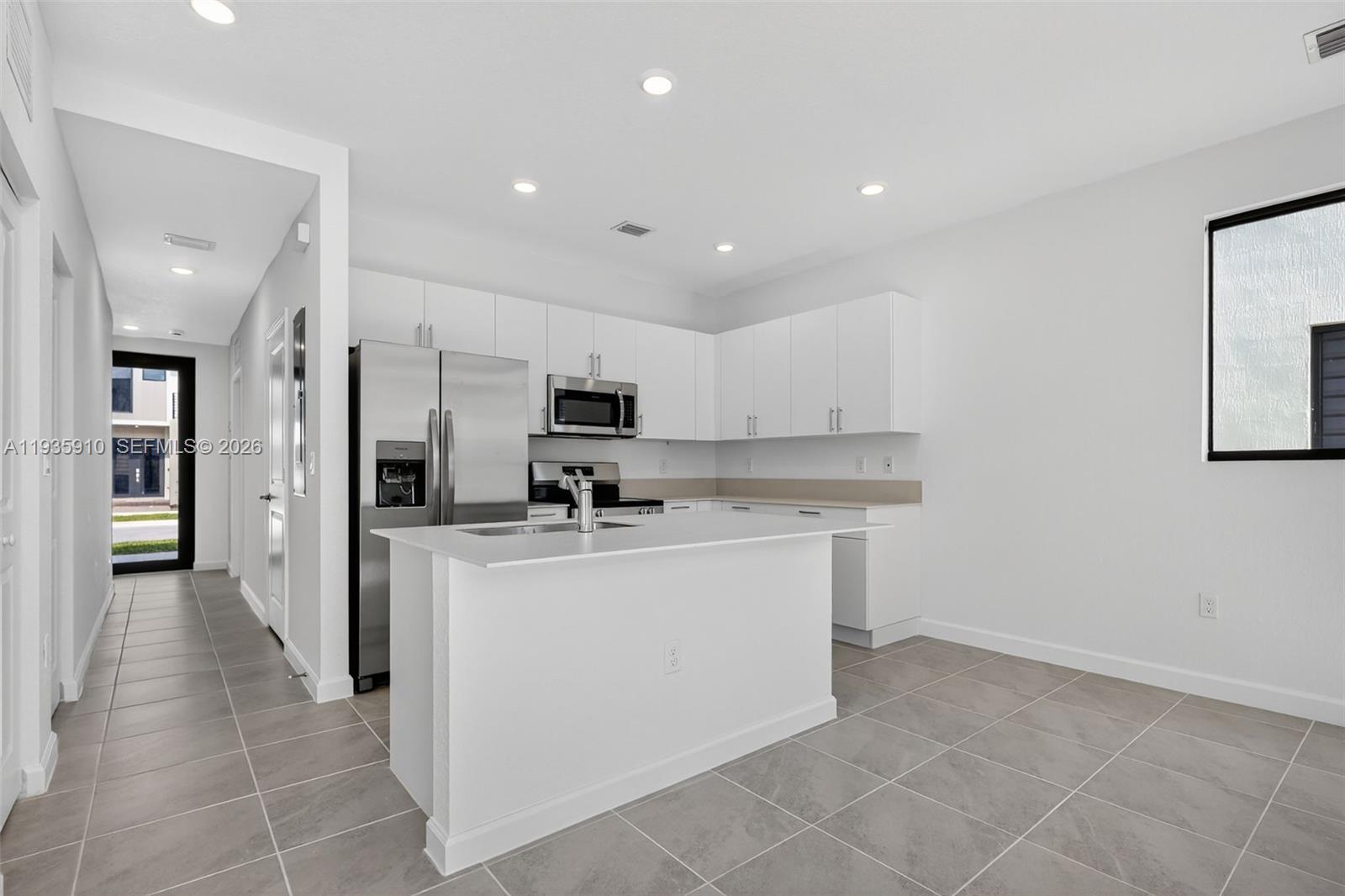 13872 Southwest 262nd Street, Unit 13862 Homestead, FL 33032 - Photo 12 of 43 a kitchen with stainless steel appliances a sink stove and cabinets
