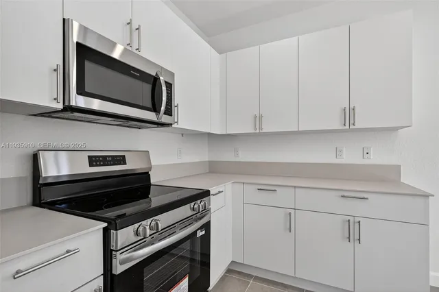 a kitchen with wooden cabinets and stainless steel appliances