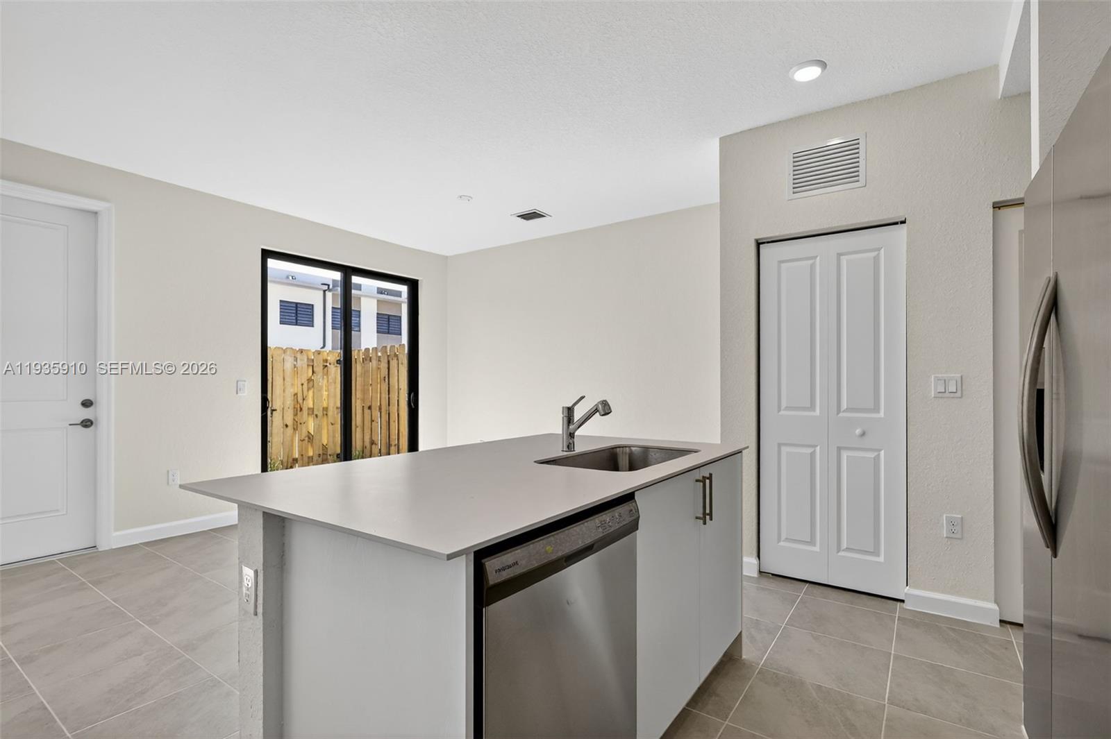 13872 Southwest 262nd Street, Unit 13862 Homestead, FL 33032 - Photo 15 of 43 a kitchen with stainless steel appliances granite countertop a sink and a refrigerator