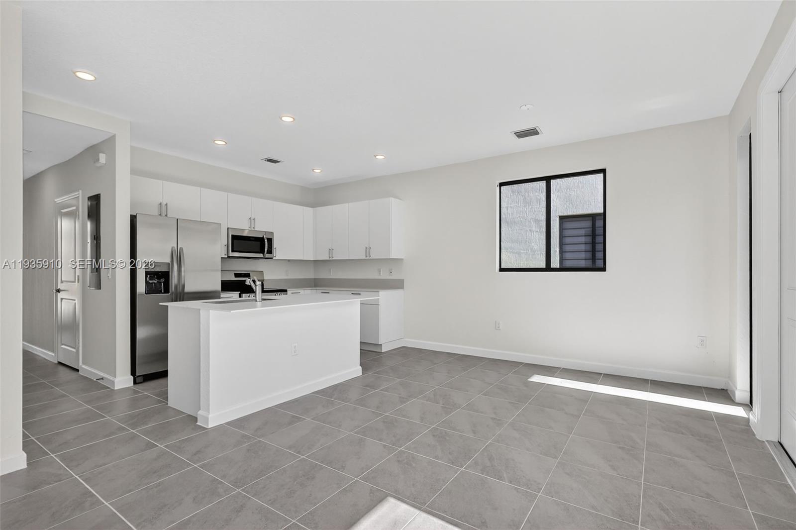 13872 Southwest 262nd Street, Unit 13862 Homestead, FL 33032 - Photo 18 of 43 a kitchen with stainless steel appliances a refrigerator sink and cabinets