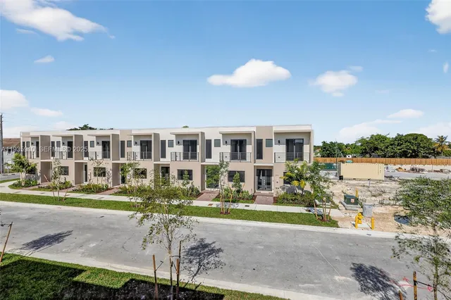 a view of a house with a swimming pool and a yard