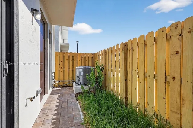 a view of a back yard from a bathroom