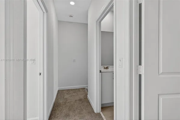 a view of a hallway with closet and door