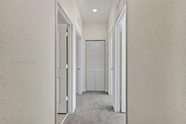 a view of a hallway with closet area
