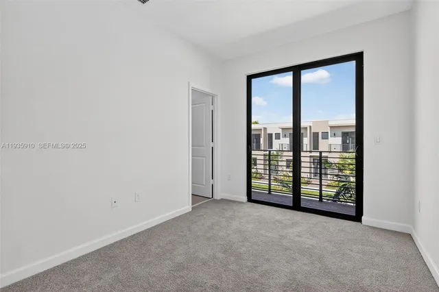 an empty room with sliding glass door