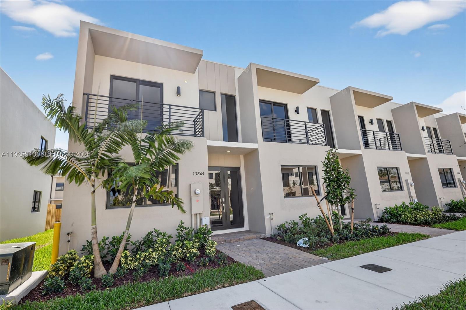 13872 Southwest 262nd Street, Unit 13862 Homestead, FL 33032 - Photo 3 of 43 a front view of a house with a yard