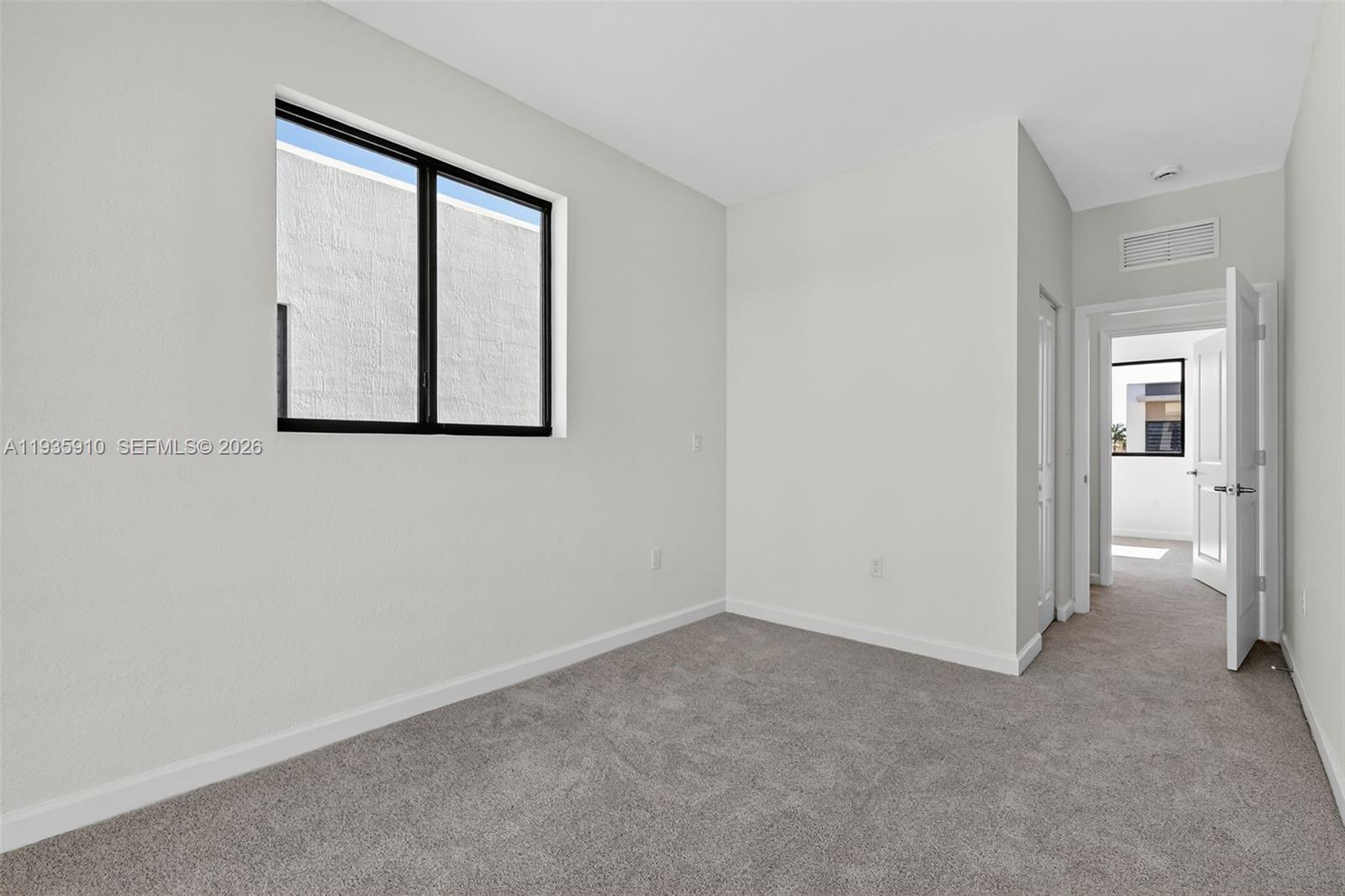 13872 Southwest 262nd Street, Unit 13862 Homestead, FL 33032 - Photo 31 of 43 an empty room with windows and closet