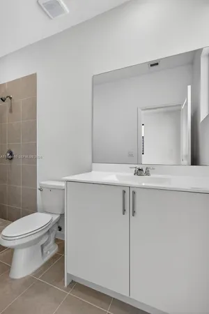 a bathroom with a toilet and shower