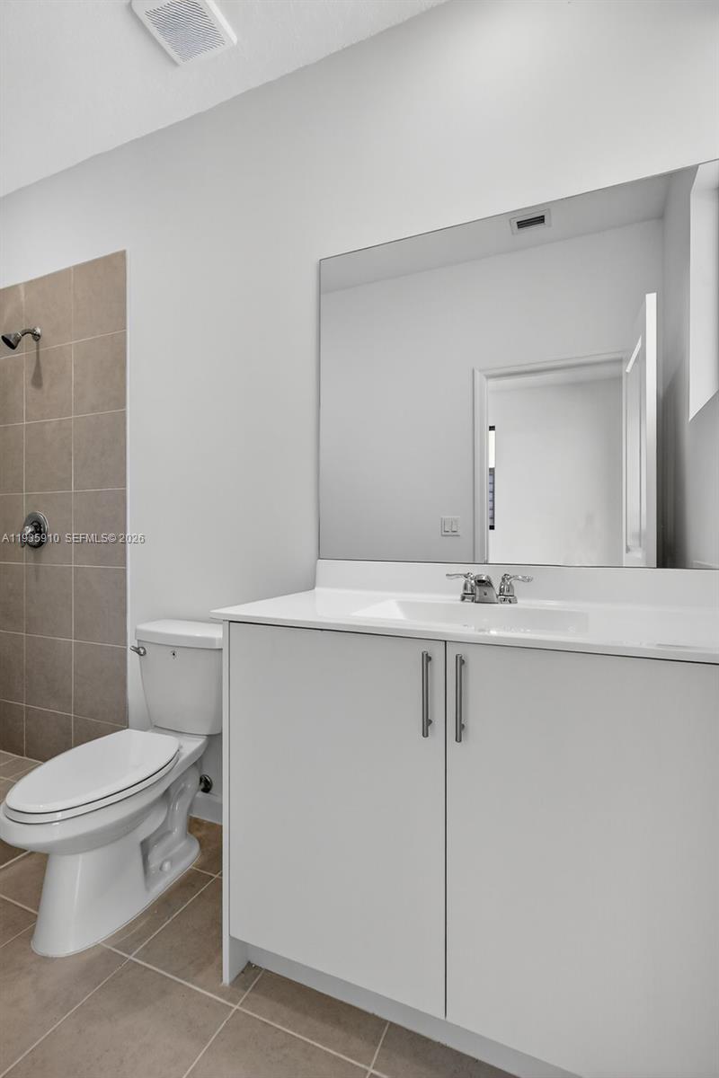 13872 Southwest 262nd Street, Unit 13862 Homestead, FL 33032 - Photo 33 of 43 a bathroom with a sink toilet and shower