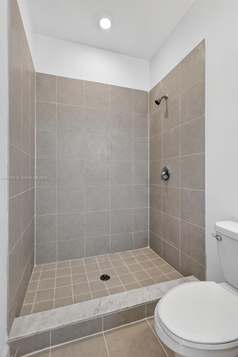 13872 Southwest 262nd Street, Unit 13862 Homestead, FL 33032 - Photo 34 of 43 a bathroom with a toilet and shower