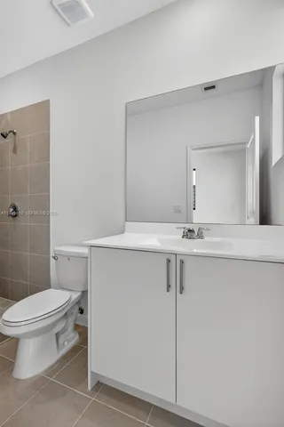 a bathroom with a toilet and shower