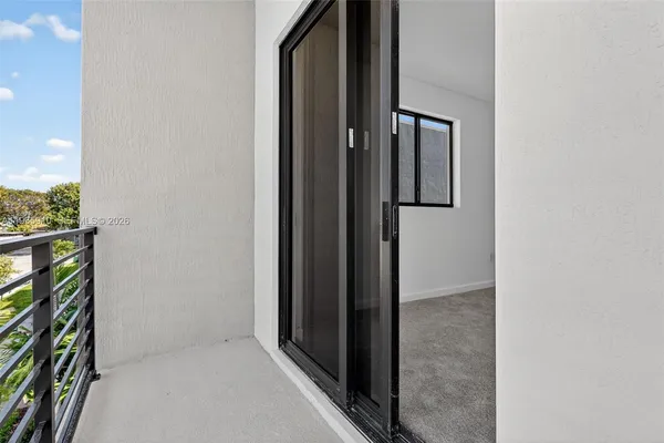 a view of a balcony with two chairs