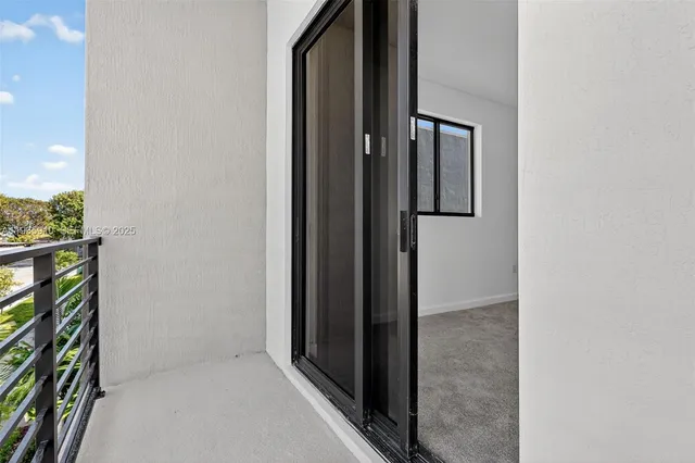 a view of a balcony with two chairs