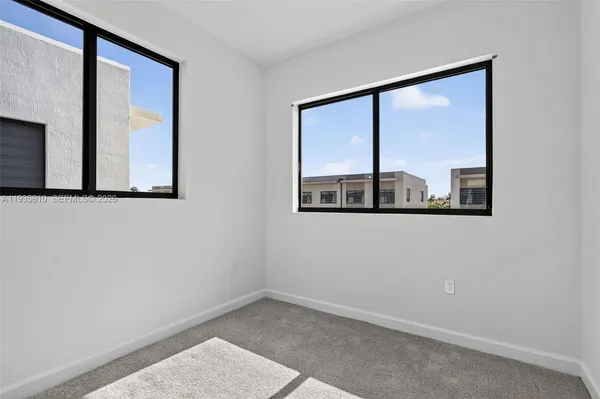 an aerial view of multiple houses with yard