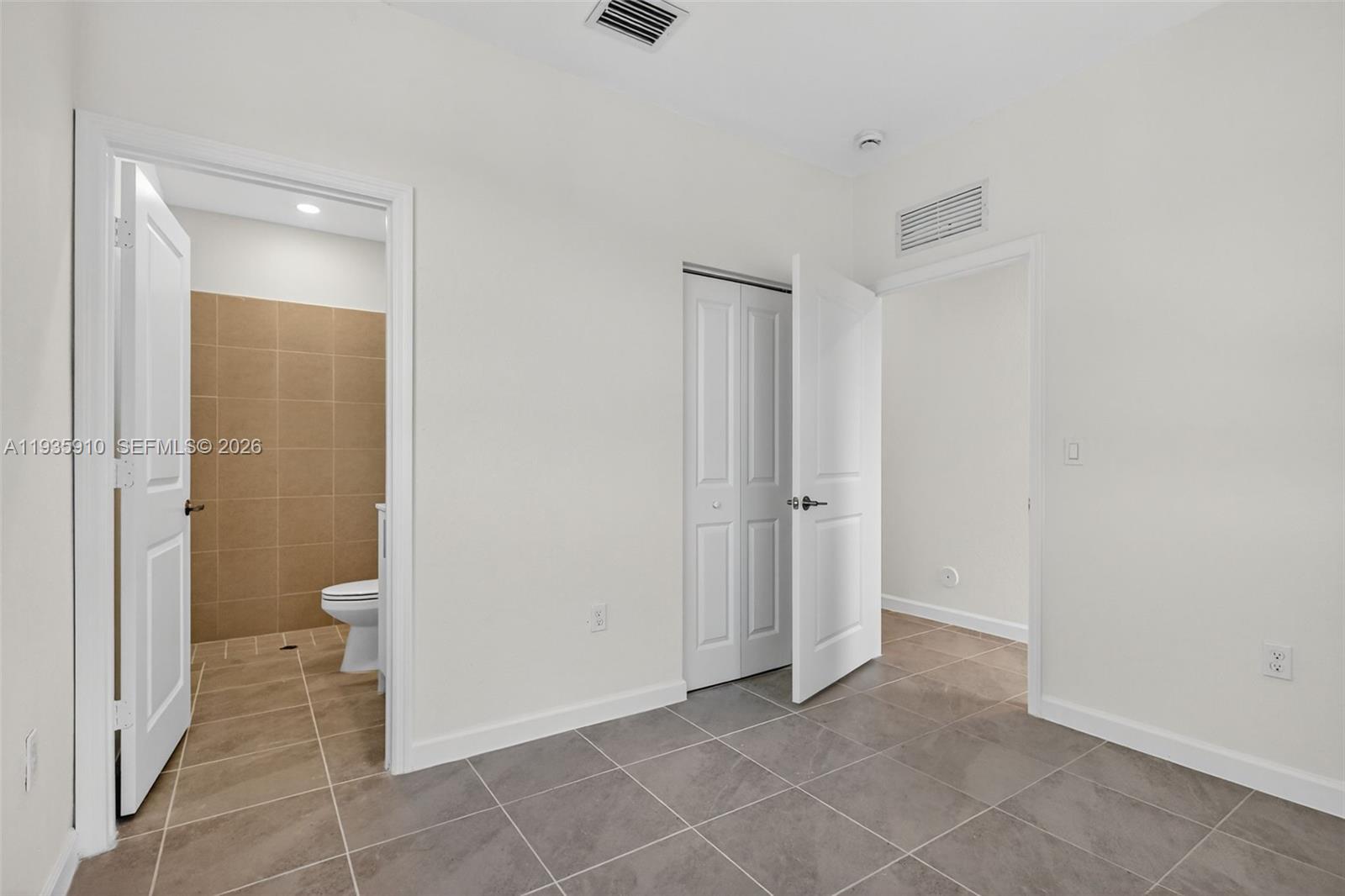 13872 Southwest 262nd Street, Unit 13862 Homestead, FL 33032 - Photo 7 of 43 a view of a bathroom with a shower and a toilet