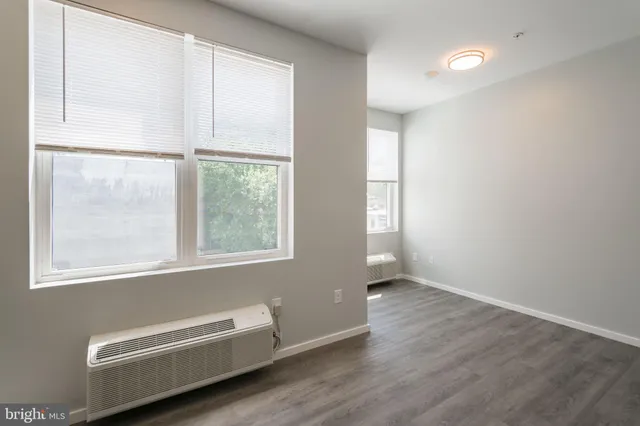 a view of room with window and a ceiling fan