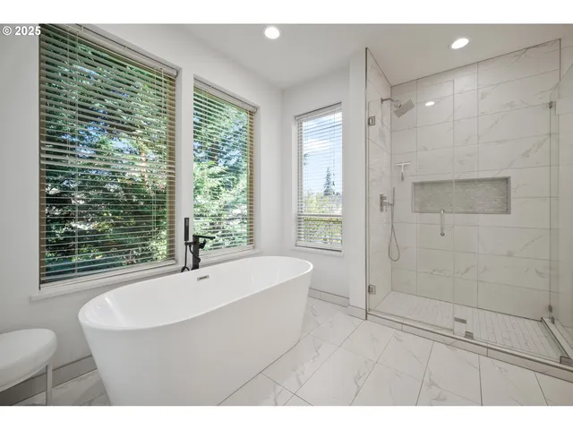 a bathroom with a bathtub a shower and a sink