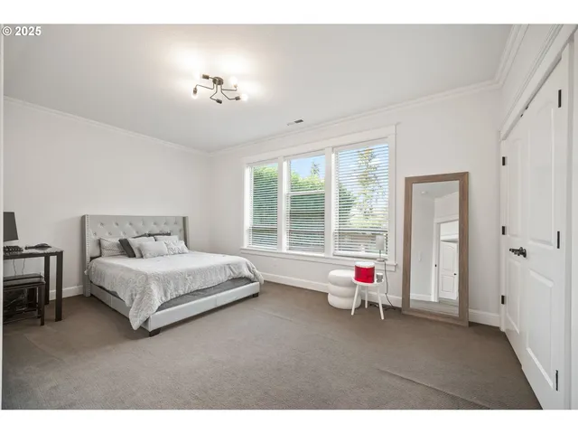 a living room with a large bed and a large window