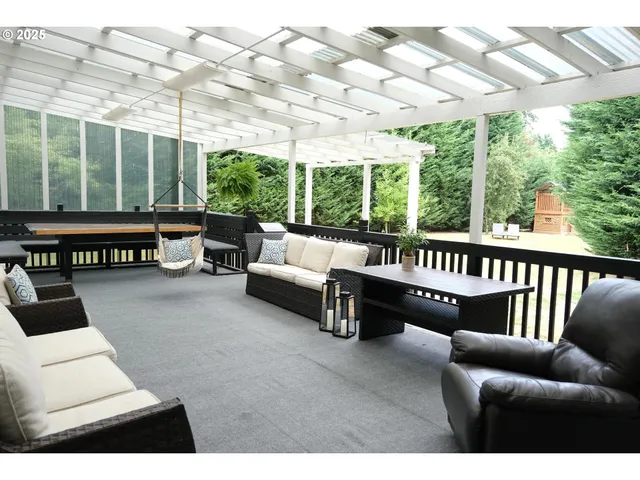 a balcony with furniture and large windows