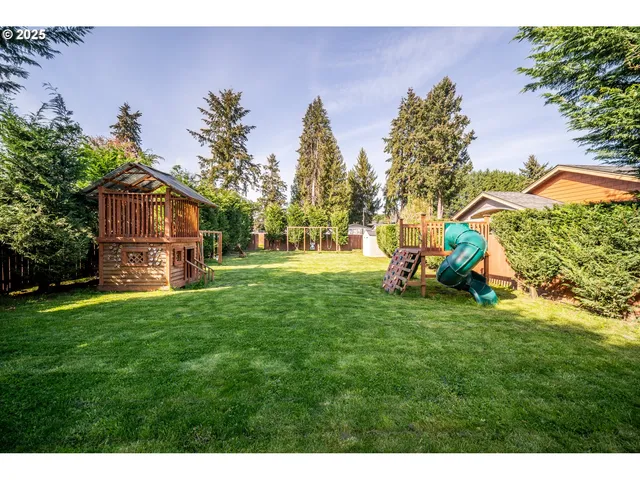 a view of a park with a house in the background