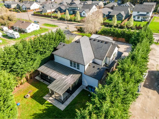 an aerial view of a house with a garden and lake view