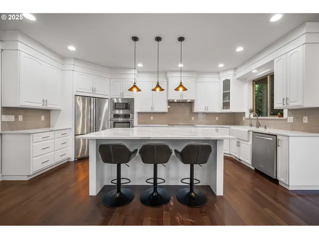 a kitchen with a sink cabinets and window