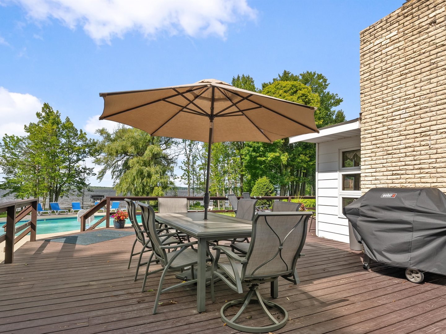 W6336 Circle Drive Crivitz, WI 54114 - Photo 34 of 52 a view of a roof deck with table and chairs under an umbrella with wooden floor