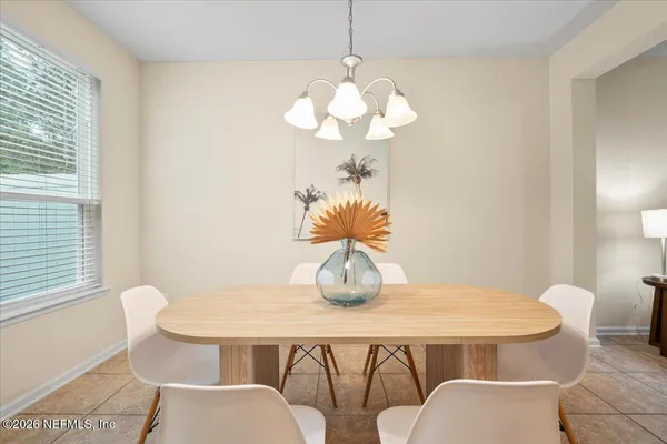 a dining room with furniture and window