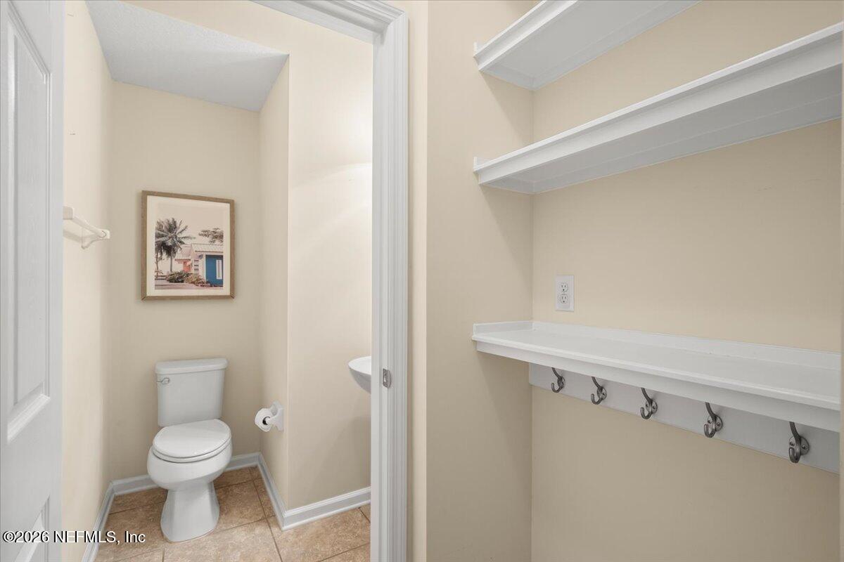 197 Paradas Place St. Augustine, FL 32092 - Photo 16 of 46 a bathroom with a toilet a sink and mirror