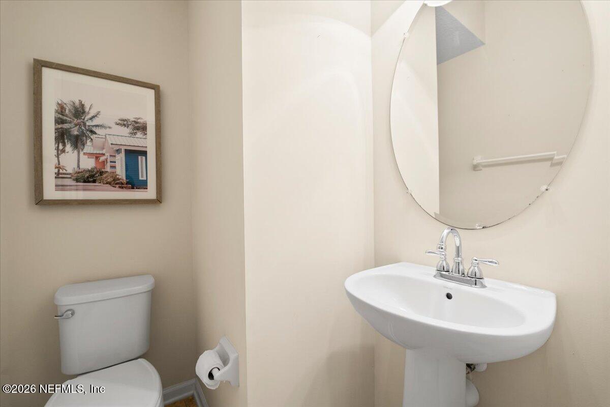 197 Paradas Place St. Augustine, FL 32092 - Photo 17 of 46 a bathroom with a toilet a sink and a mirror