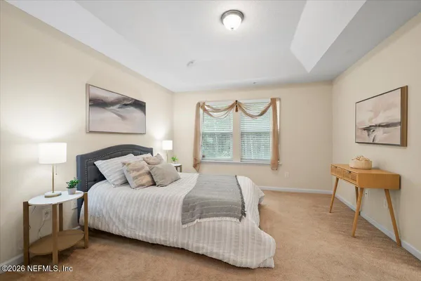 a bedroom with a bed and a lamp on table