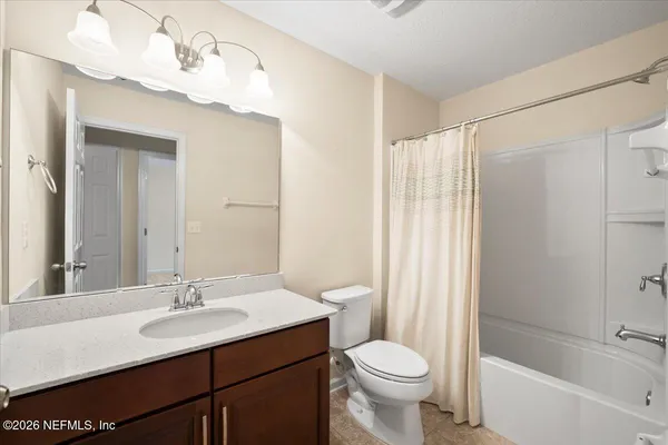a bathroom with a sink toilet a mirror and shower