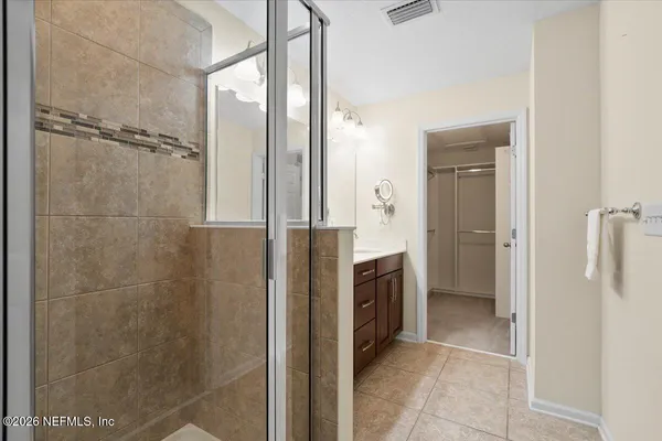 a bathroom with a shower and a sink