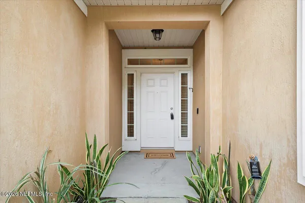 a view of a hallway with wooden door
