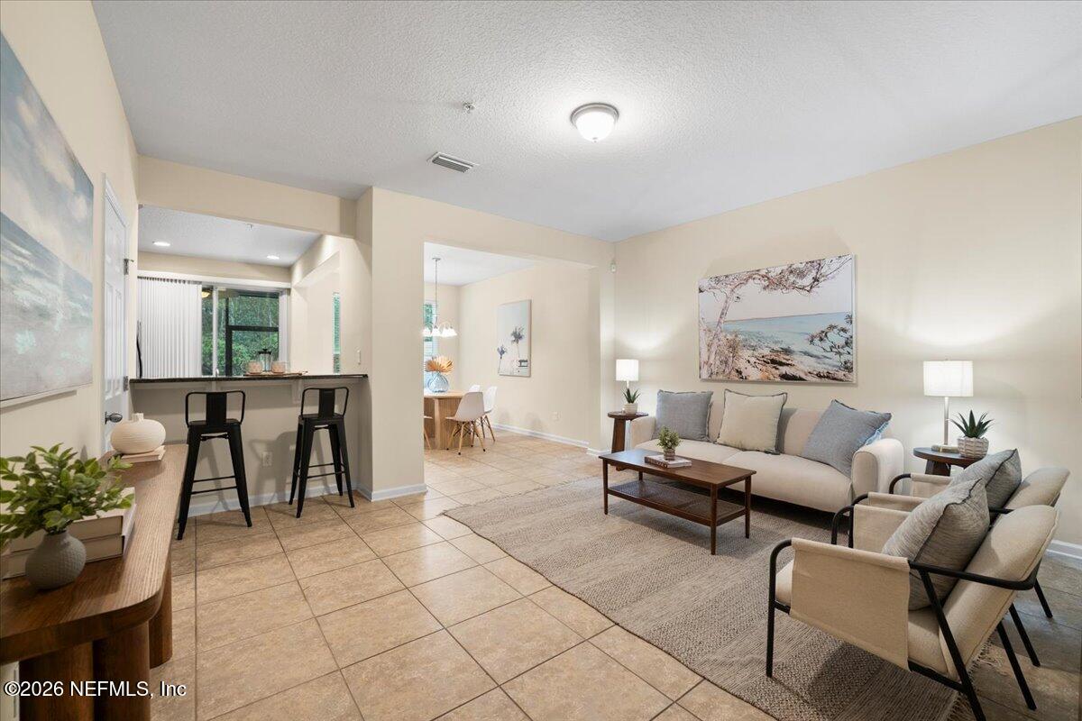 197 Paradas Place St. Augustine, FL 32092 - Photo 6 of 46 a living room with furniture a dining table and a potted plant