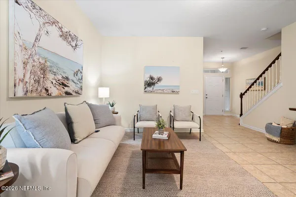 a living room with furniture and a painting