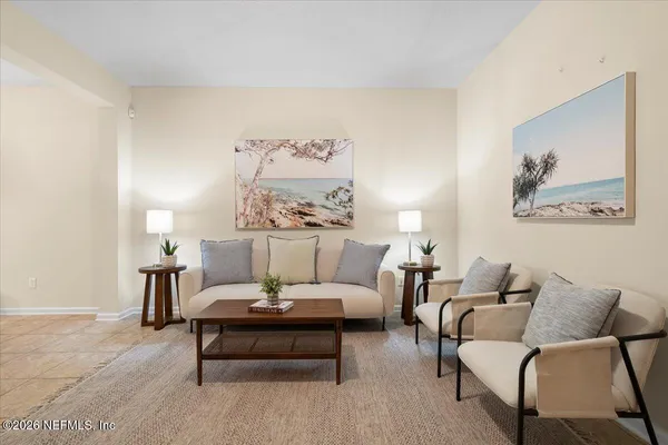 a living room with furniture and a lamp